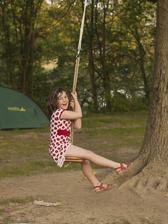 child on a rope swing at St Ives Farm campsite
